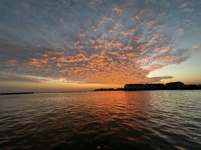 Orange sunrise clouds over the bay