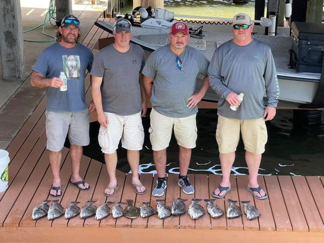 Crew lined up on the dock with the catch