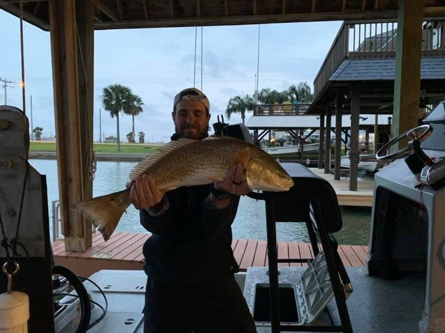 Redfish held up under the covered dock