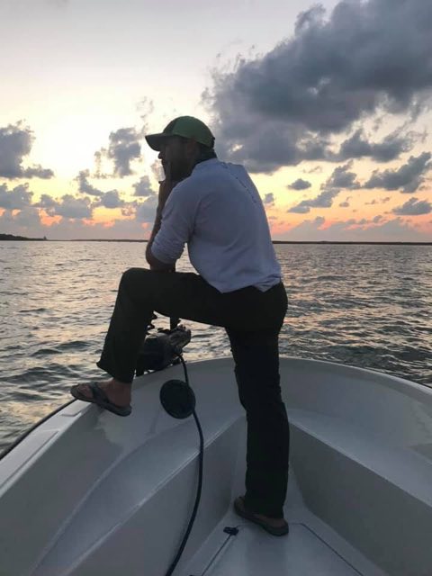 Captain on the bow at first light