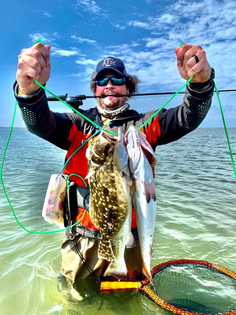 Wading angler with a flounder on the stringer
