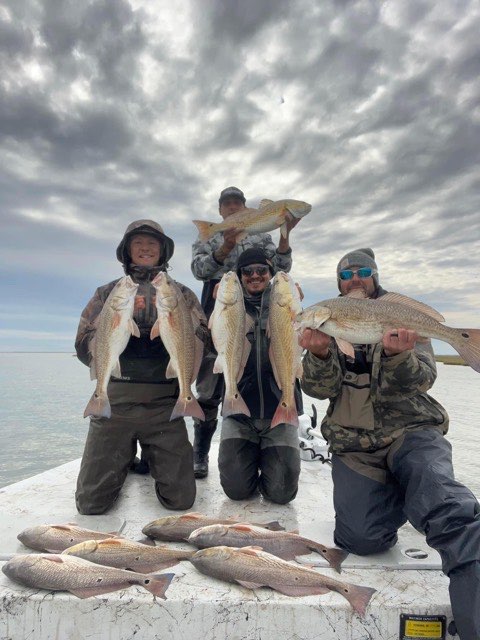 Three anglers with the day's catch on the deck