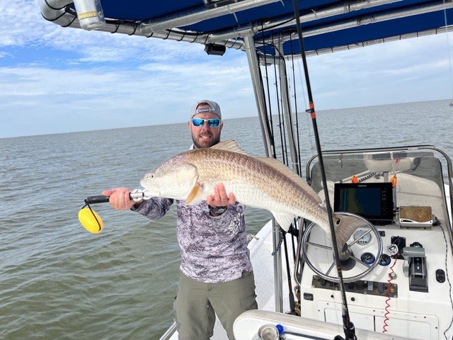 Angler with a redfish under the T-top