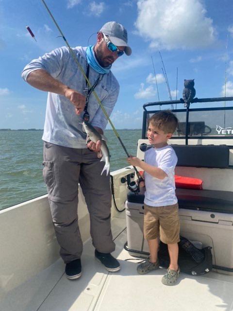 Angler and a young angler showing off a fish