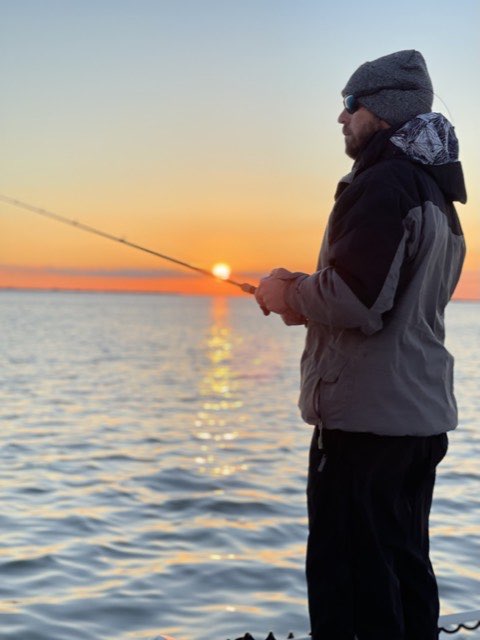 Angler casting into the sunrise