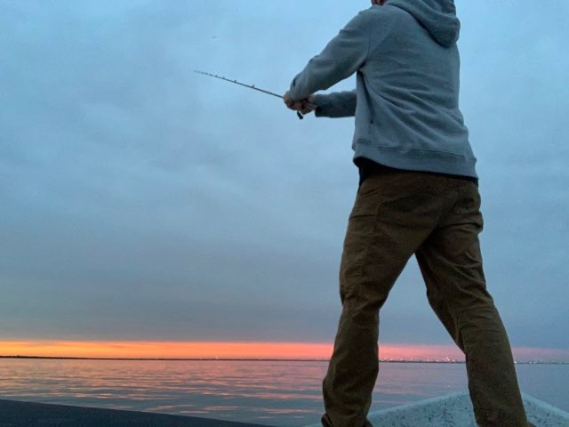 Angler casting at dawn