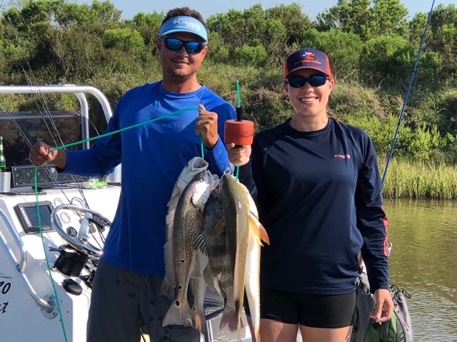 Two anglers with their catch on the boat