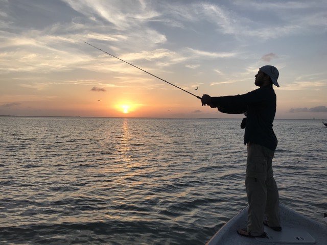 Angler casting at sunset