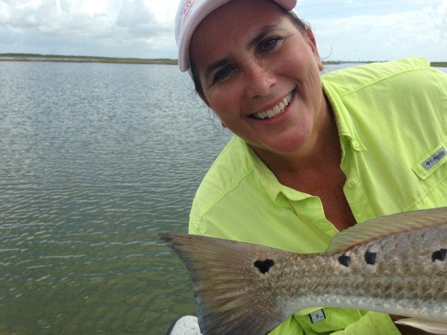 Smiling angler with a speckled trout
