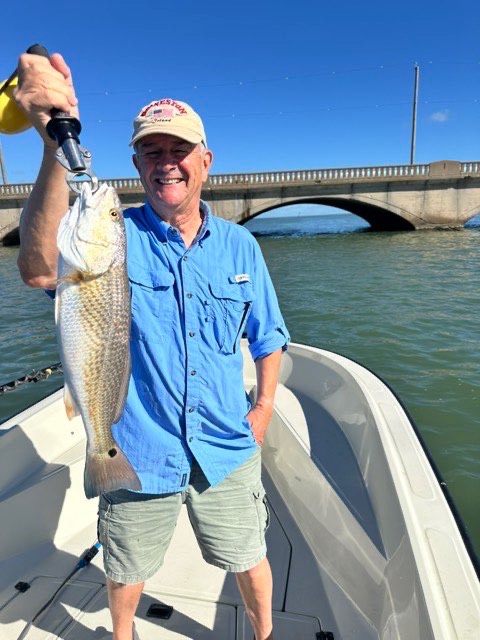 Angler with a redfish near the causeway
